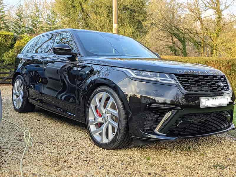 Detailer polishing car paint to remove swirls